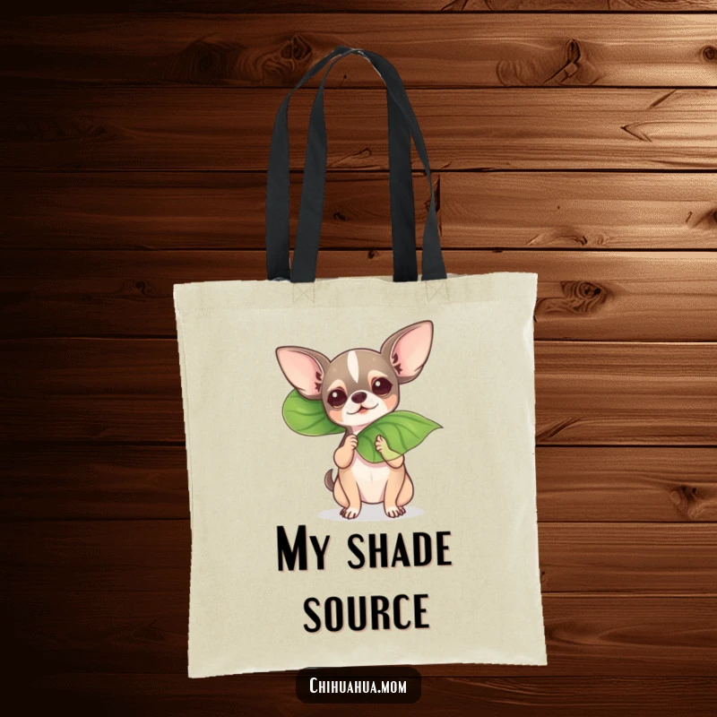 Funny chihuahua fanning itself with a leaf on a tote bag, a humorous way to carry essentials.
